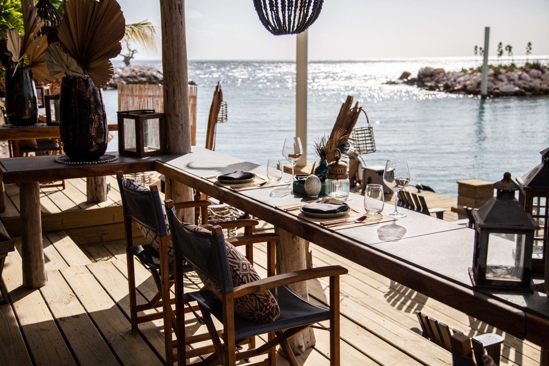 A table set-up for dining with the sea in the background