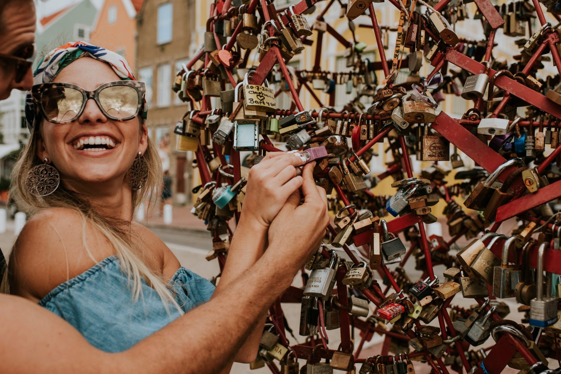 A woman putting a lock on the Punda love heart