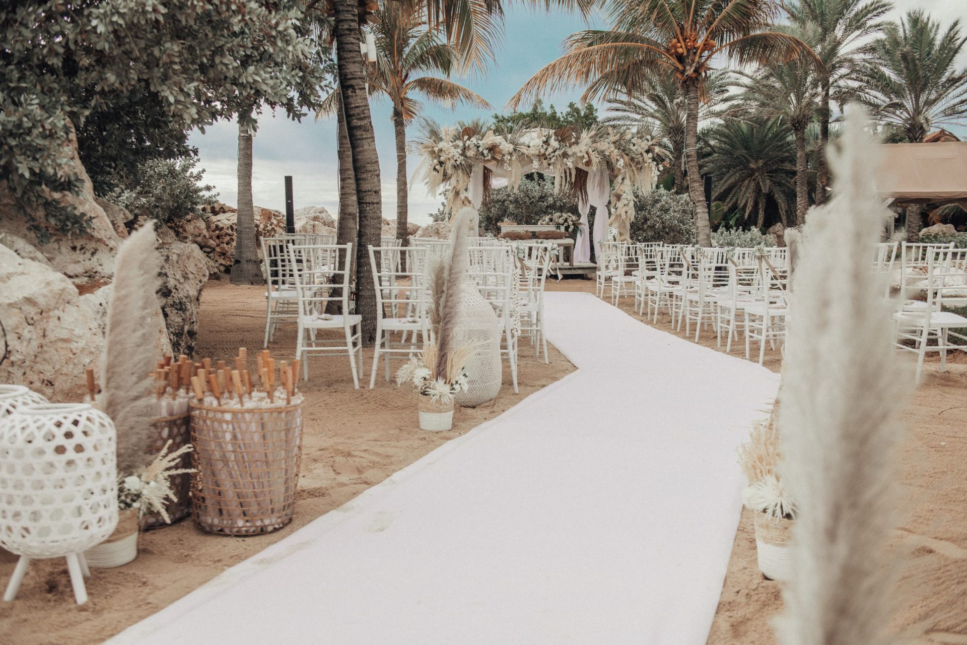 Beach area at Baoase set-up for a wedding with a wedding pergola, chairs and decoration