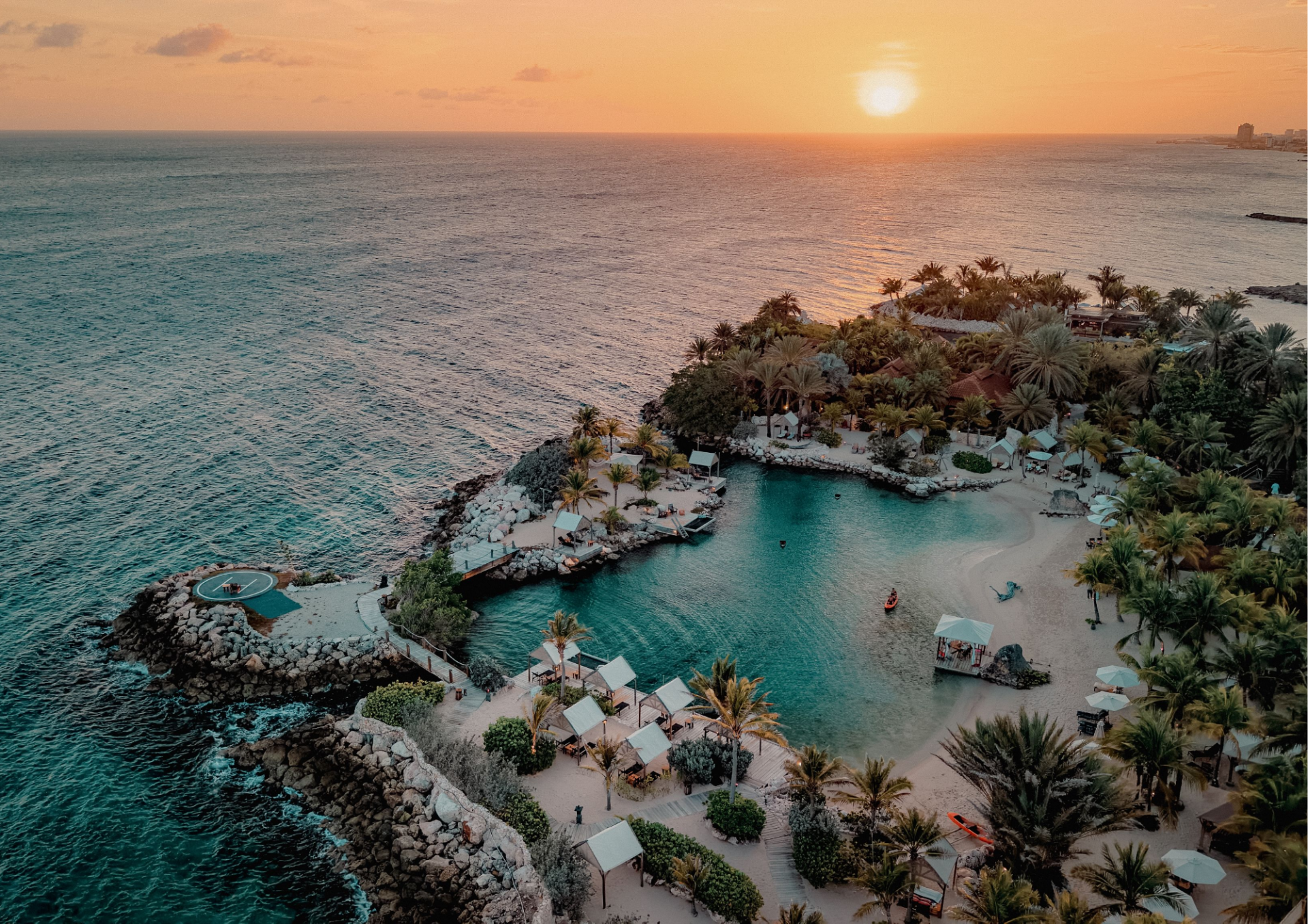 Aerial view of Baoase Curaçao at sunset, overlooking the Caribbean Sea and private beach.